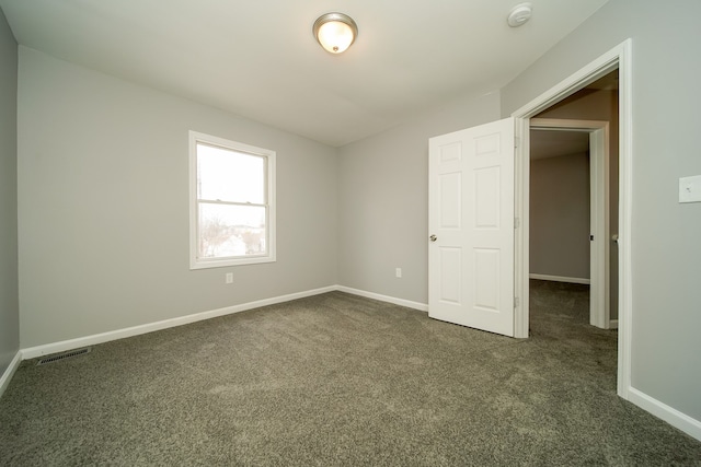 empty room featuring dark colored carpet