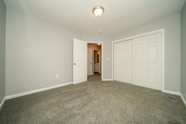 unfurnished bedroom featuring a closet and carpet flooring