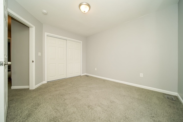 unfurnished bedroom with carpet floors and a closet