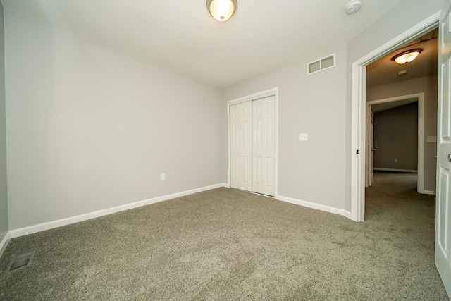 unfurnished bedroom with carpet floors and a closet