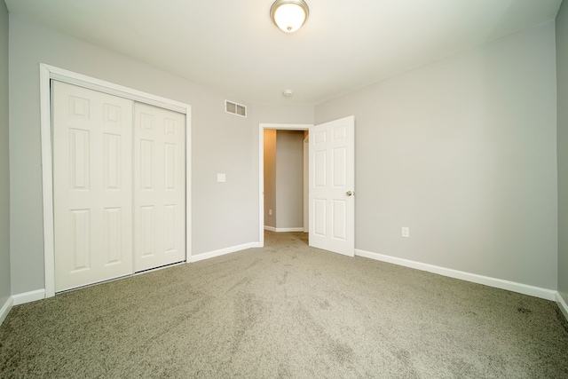 unfurnished bedroom featuring carpet floors and a closet