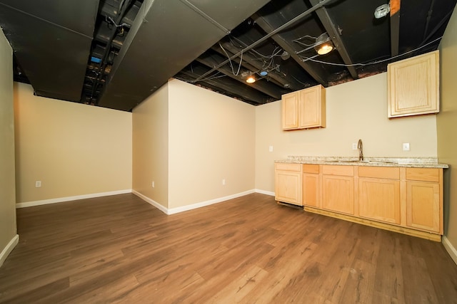 kitchen with dark wood-type flooring, light brown cabinetry, and sink