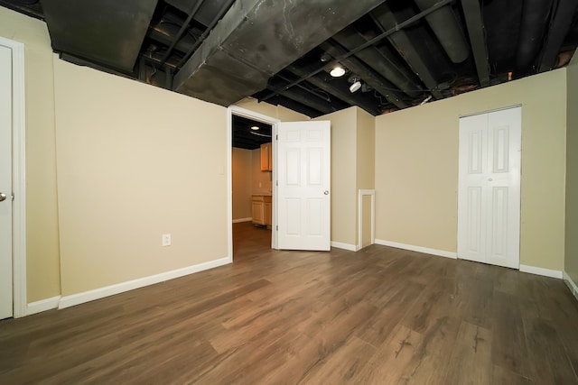 basement featuring dark hardwood / wood-style floors