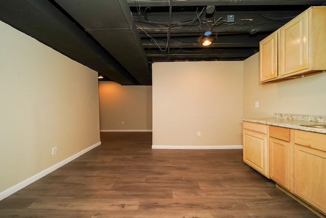 basement with dark hardwood / wood-style floors