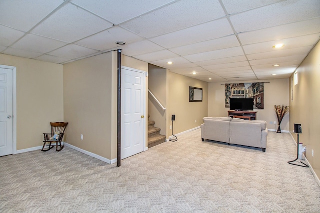 living room featuring light colored carpet and a drop ceiling