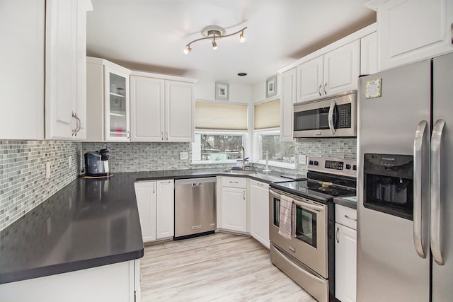 kitchen featuring white cabinetry, decorative backsplash, and appliances with stainless steel finishes