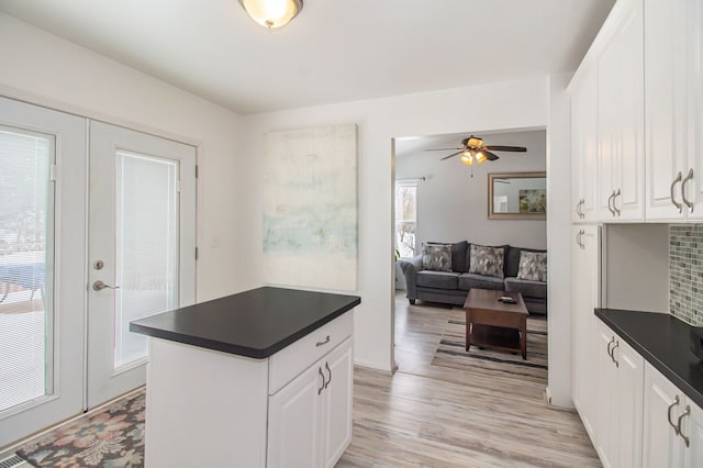 kitchen featuring white cabinetry, french doors, ceiling fan, and light wood-type flooring