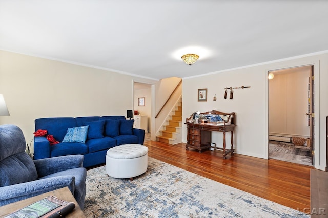 living room with dark hardwood / wood-style flooring, a baseboard heating unit, and ornamental molding