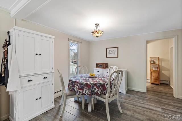 dining area featuring dark wood-type flooring and a baseboard radiator