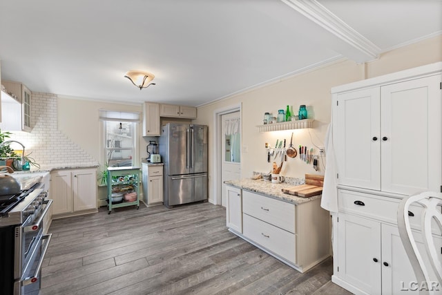 kitchen featuring decorative backsplash, ornamental molding, stainless steel appliances, and wood-type flooring