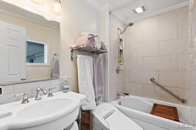 bathroom featuring crown molding, tiled shower / bath combo, sink, and tasteful backsplash