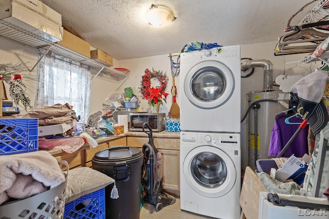 laundry area featuring stacked washer and dryer, light tile patterned flooring, secured water heater, and a textured ceiling