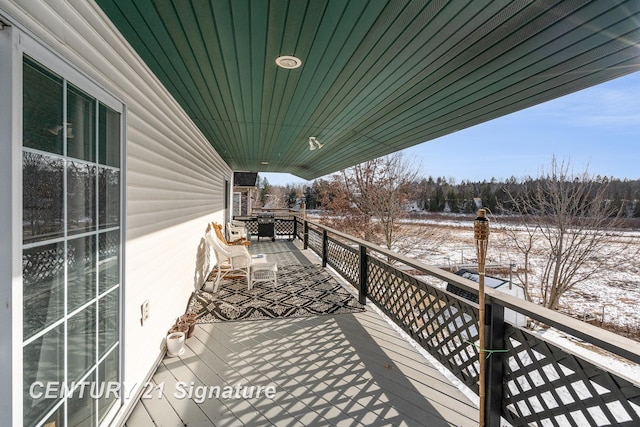 view of snow covered back of property