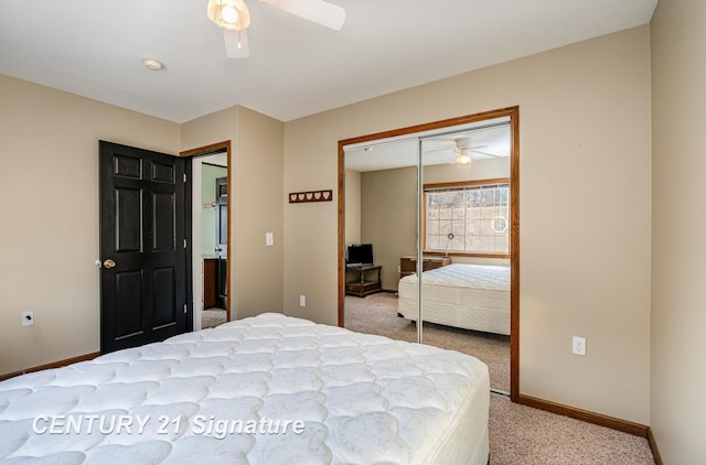 bedroom with a ceiling fan, a closet, light carpet, and baseboards