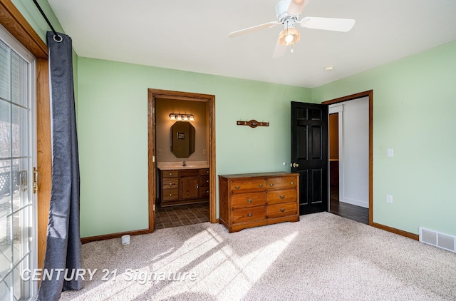 unfurnished bedroom with a sink, baseboards, visible vents, and carpet flooring