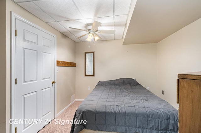 bedroom featuring a ceiling fan, carpet flooring, a paneled ceiling, and baseboards