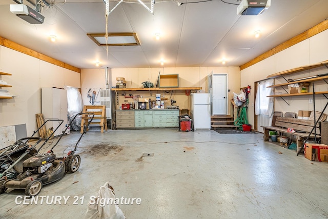 garage featuring a garage door opener and freestanding refrigerator