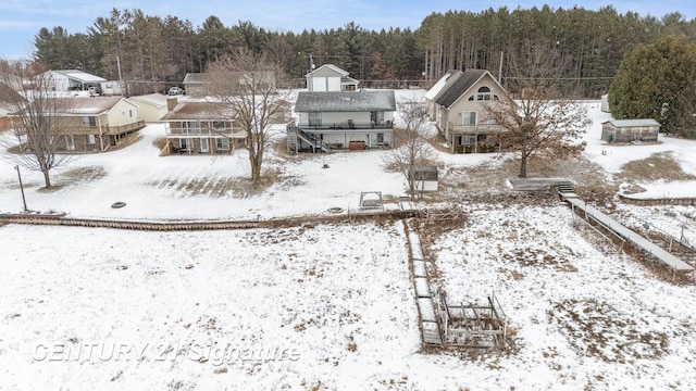 snowy aerial view featuring a view of trees