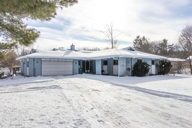 ranch-style home featuring a garage