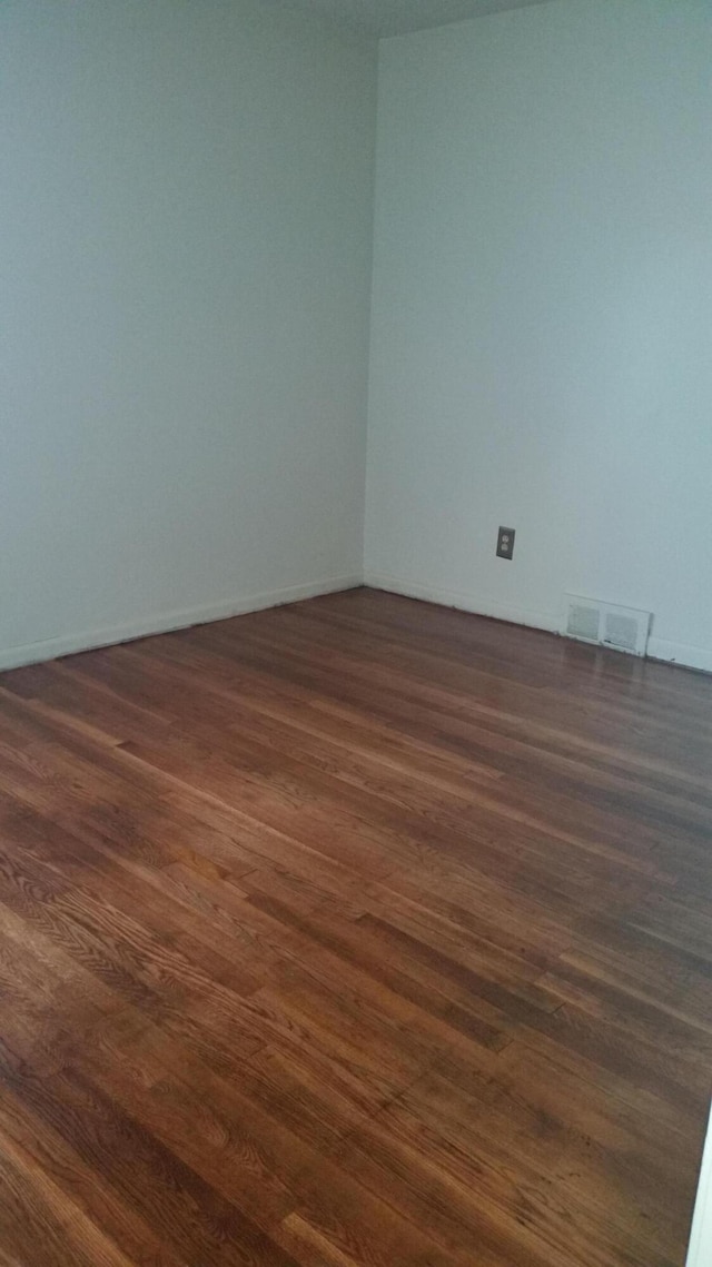 empty room featuring dark wood-type flooring