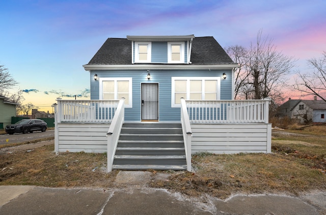 bungalow-style home with a wooden deck