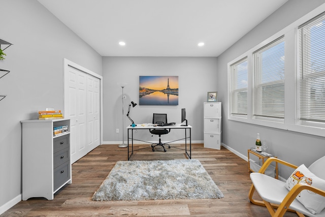 home office with dark hardwood / wood-style floors