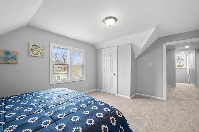 carpeted bedroom featuring lofted ceiling