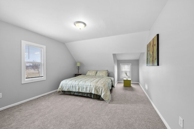 carpeted bedroom with vaulted ceiling