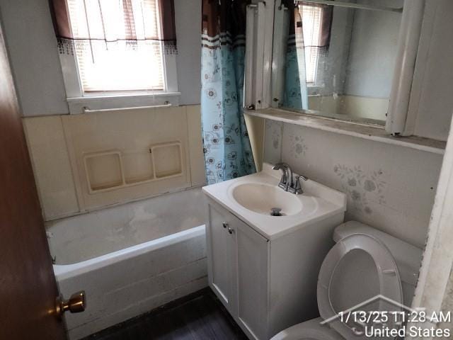 full bathroom with vanity, shower / bath combination with curtain, and toilet