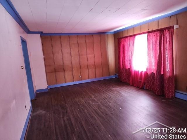 unfurnished room with dark hardwood / wood-style flooring