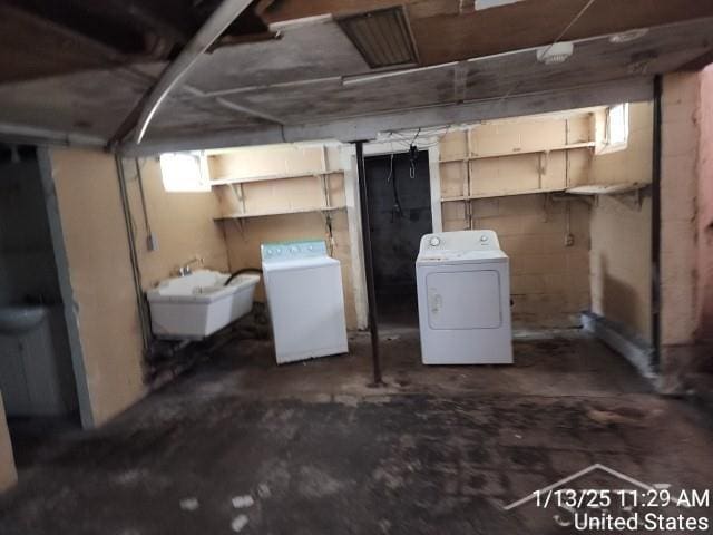 basement with sink and washing machine and clothes dryer