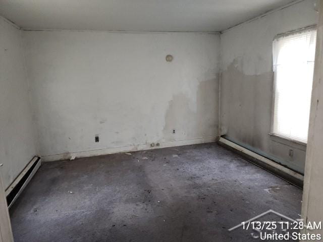 unfurnished room with a baseboard radiator