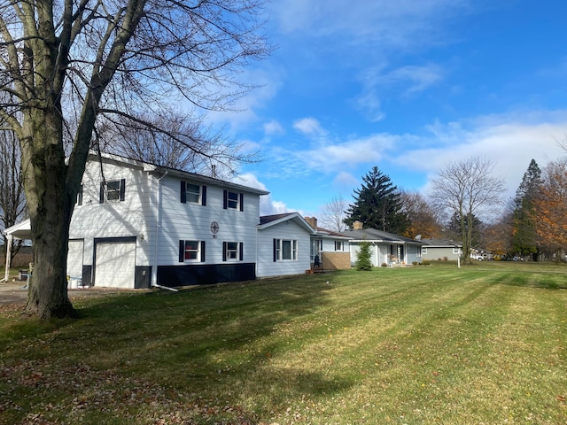 exterior space with a garage and a yard