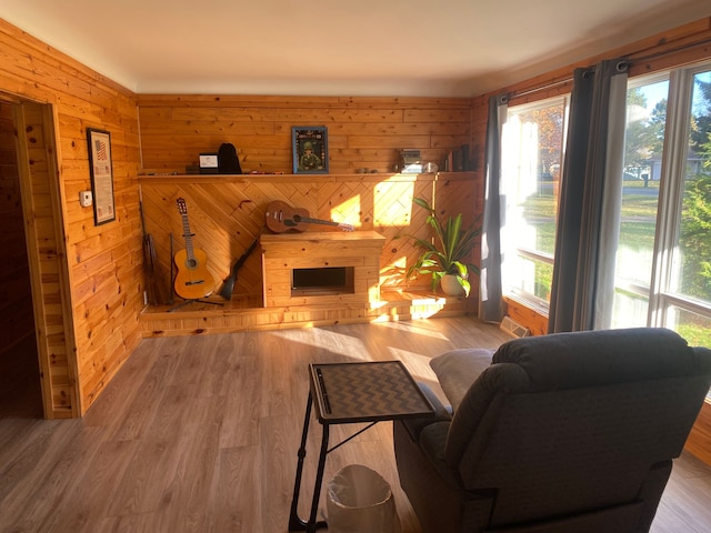 living room featuring hardwood / wood-style flooring and wood walls