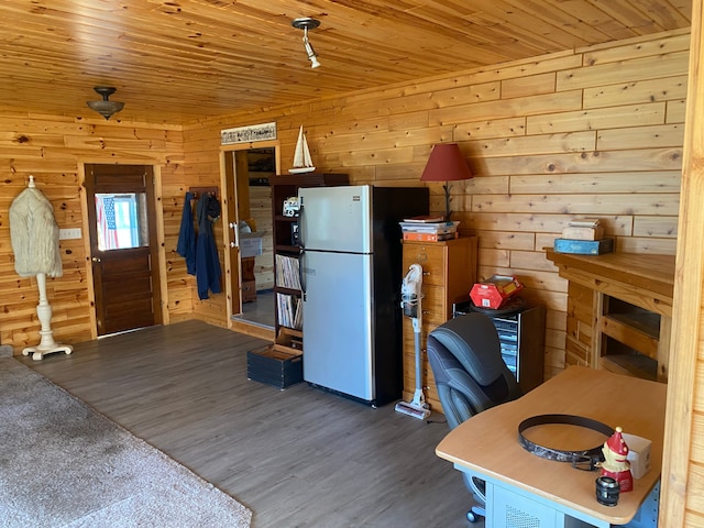 kitchen with dark wood-type flooring, wood walls, stainless steel fridge, and wooden ceiling