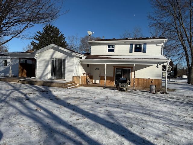 view of snow covered rear of property