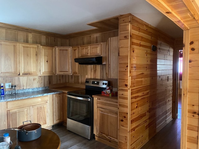 kitchen with dark hardwood / wood-style floors, wood walls, light brown cabinetry, and electric stove