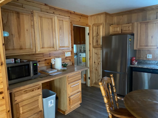 kitchen with stainless steel appliances, dark hardwood / wood-style floors, light brown cabinets, and water heater