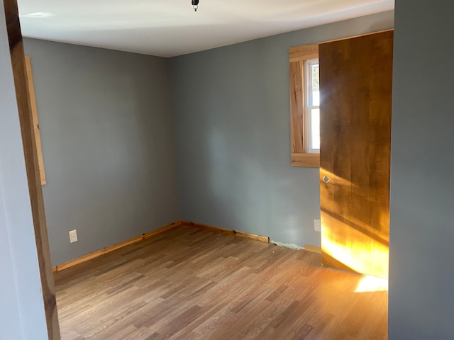 spare room with light wood-type flooring