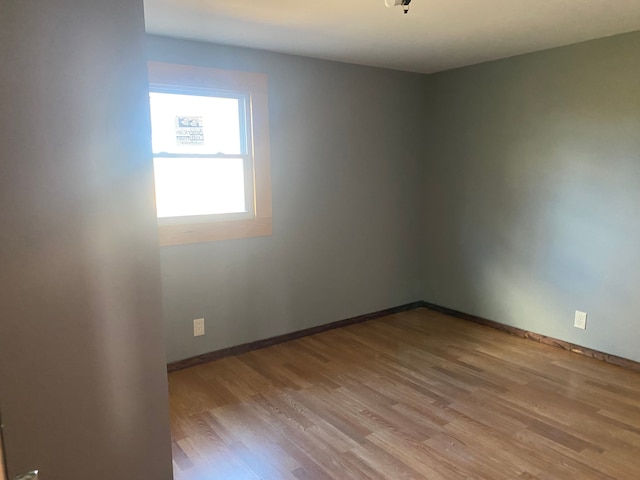 empty room with light hardwood / wood-style flooring