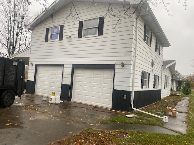 view of side of home with a garage