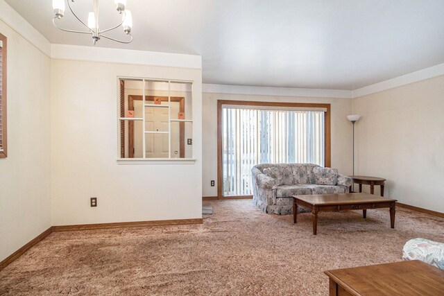 carpeted living room with a notable chandelier