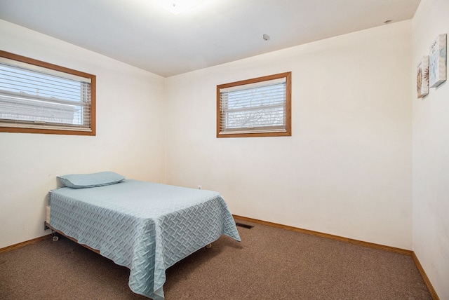 bedroom with multiple windows, carpet, visible vents, and baseboards