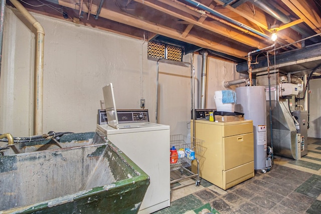 basement featuring washer and dryer, sink, water heater, and heating unit