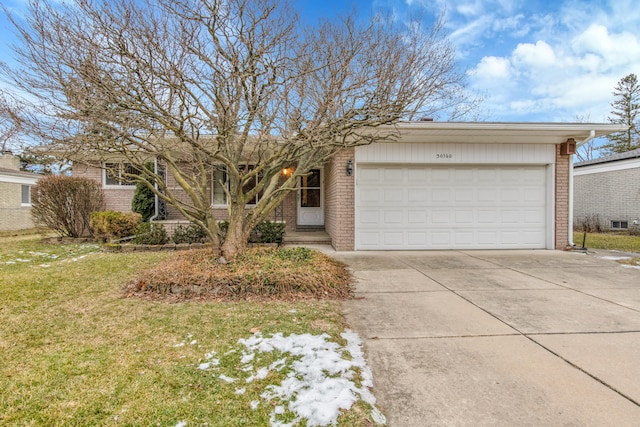 single story home featuring a garage and a front yard