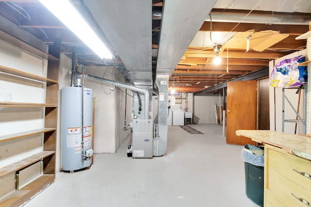 basement with water heater, separate washer and dryer, and heating unit