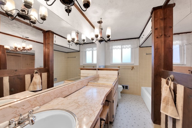 full bathroom featuring toilet, crown molding, tile walls, a textured ceiling, and vanity