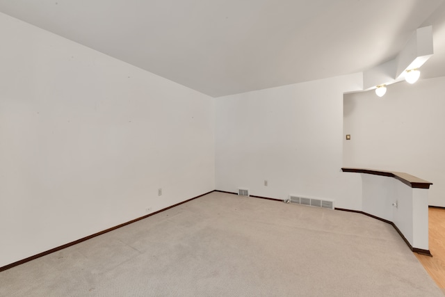 spare room featuring light colored carpet