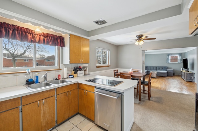 kitchen with sink, black electric stovetop, decorative backsplash, stainless steel dishwasher, and kitchen peninsula