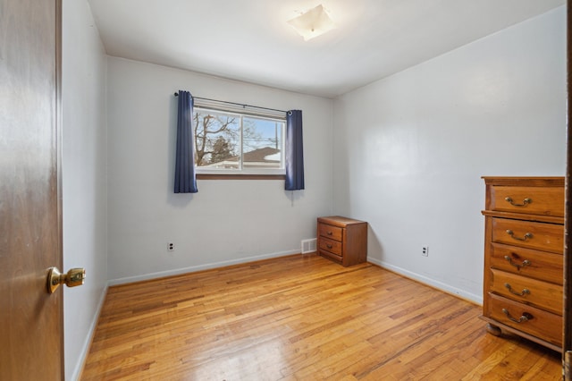 empty room with light hardwood / wood-style flooring